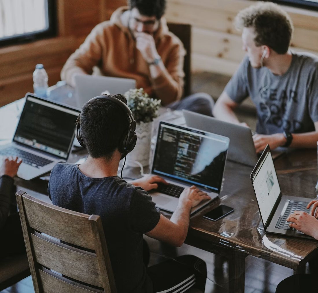 The SeptiBytes team collaborating on laptops around one table
